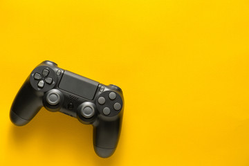 black gamepad on a yellow. Gaming concept © solidmaks