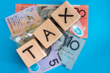 australian dollar with wooden cubes tax time