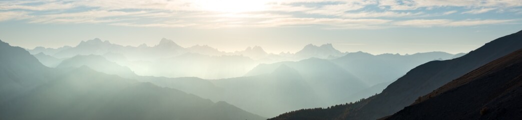 Fototapeta na wymiar The Alps in Italy at sunset, famous travel destination in summertime. Ultra wide panoramic view