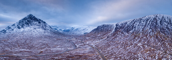 landscape view of scotland and buchaille etive more near glen coe in the highlands of scotland in winter from an aerial viewpoint in panoramic landscape format - obrazy, fototapety, plakaty