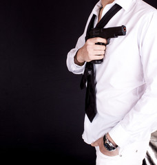 Fototapeta na wymiar Man in black suit holding gun in hand. Secret agent, mafia, bodyguard concept.