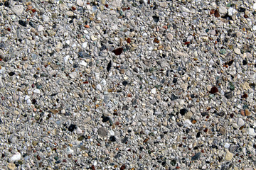 Smooth surface of an artificial conglomerate rock concrete cement wall