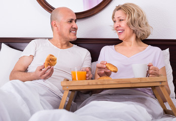 adults posing with coffee and pastry