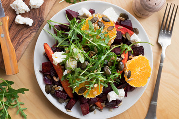 Vegetable salad - baked beets and carrots, oranges, arugula, goat cheese