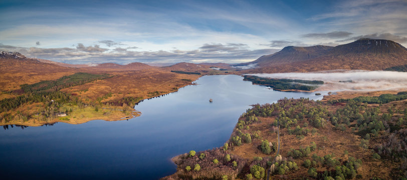 landscape view of scotland and loch tulla in the remote highlands of scotland during winter from an aerial viewpoint in panoramic landscape foramt