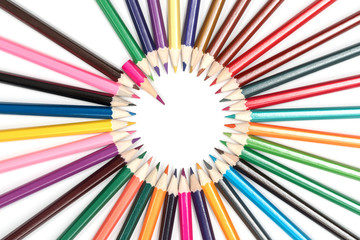 Circle of pencils, sharpened side in the center with a pointer in the form of a short pink pencil