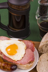 Ulster Fry Breakfast. 
Bacon, Egg, and a sausage sat on a slice of toasted Sour dough bread, with freshly brewed coffee.

