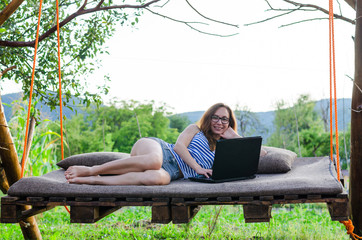 Woman freelancer working on laptop, outdoor.