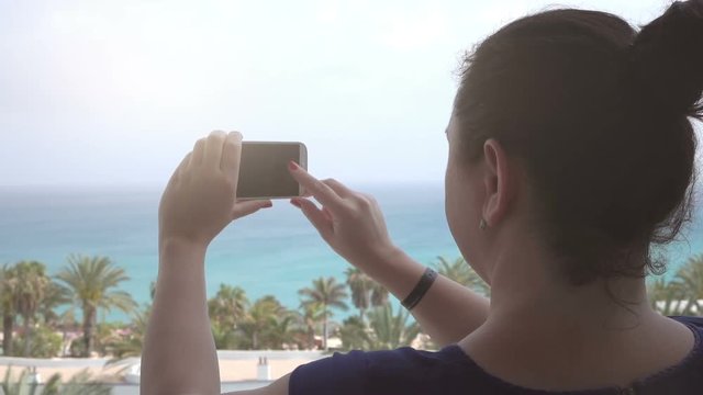 High quality video of woman taking a picture on the vacations on canary islands in real 1080p slow motion 120fps