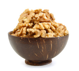 Walnut in wooden bowl on white