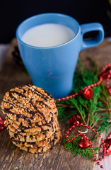 Nut biscuits with icing and a cup of milk