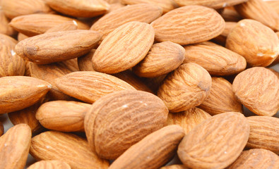 Pile of almonds close-up as background.