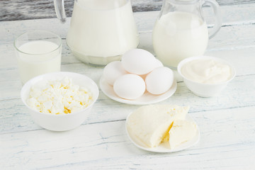 Different dairy products, white wooden background
