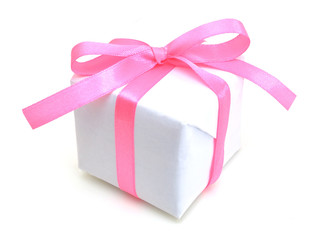 White gift box with pink ribbon bow, isolated on white