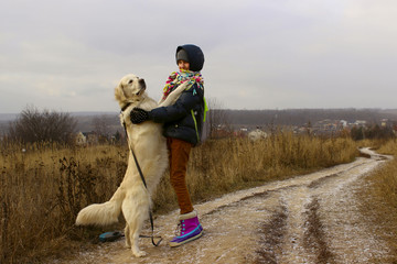 Dog Playing With Owner. Young Girl Playing With Her Pet Golden Retriever. Dog And Owner, Outdoor. Golden Retriever Playing  Outdoor.
