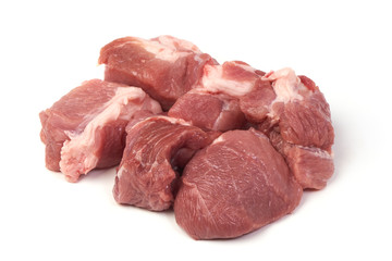 Raw pork pieces, close-up, isolated on white background.