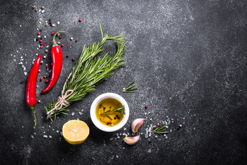 Selection of spices and herbs on dark.