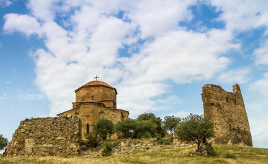 Fototapeta na wymiar An ancient monastery on a hill. Monastery in the mountains. Georgian orthodox monastery of the 6th century. Jvari Monastery, Georgia