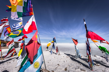 Uyuni Salt Flats - July 20, 2017: Flags landmark at the Uyuni Salt Flats, Bolivia