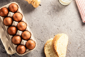 Farm raw fresh egg in pack bread milk on gray table scrambled eggs omelet fried egg