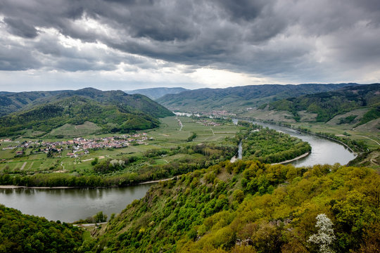 Landscape around the river Donau. Green landscape, dramatic sky, village, hills and horseshoe river.
