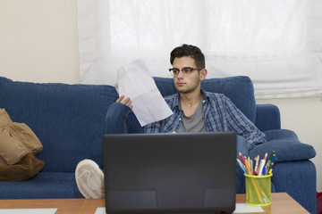 young student or adult at home working