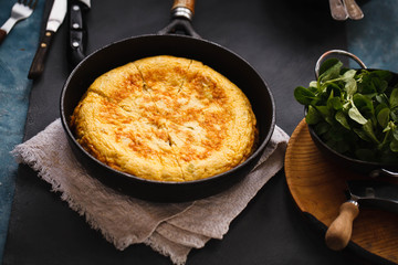 Cast iron skillet with broccoli egg frittata