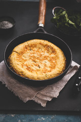 Cast iron skillet with broccoli egg frittata
