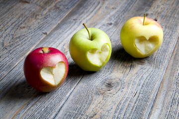 Apples with a cut heart on the wood