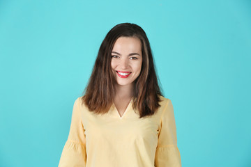 Fototapeta premium Portrait of beautiful smiling woman on color background