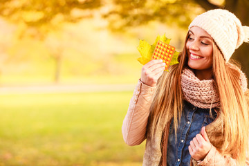 Woman in autumn park holding vitamins medicines - obrazy, fototapety, plakaty