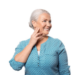 Portrait of smiling mature woman on white background