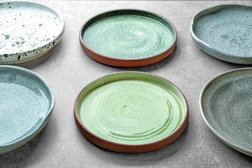 Ceramic plates on grey background