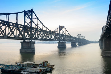 Yalu River Bridge. In the distance is North Korea. Located in Dandong, Liaoning, China.