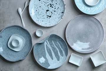 Ceramic tableware on grey background
