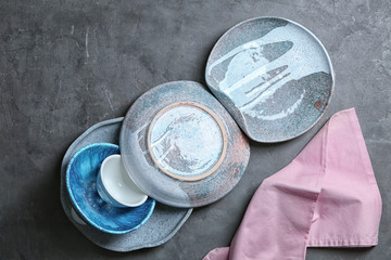 Ceramic tableware on grey background