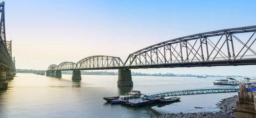 Yalu River Bridge. In the distance is North Korea. Located in Dandong, Liaoning, China.
