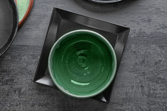 Ceramic tableware on grey background