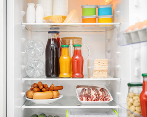 Fototapeta na wymiar Different products on refrigerator shelves