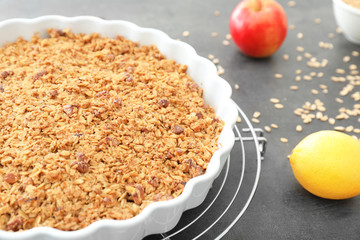 Baking dish with apple crisp on table