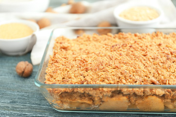 Glass baking dish with apple crisp on table