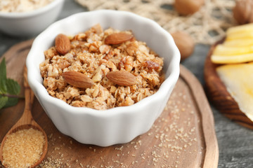 Ramekin with apple crisp on wooden board, closeup