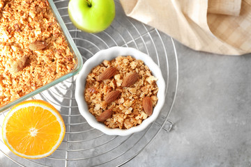 Ramekin with apple crisp and fruits on cooling rack, top view