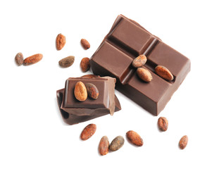 Tasty chocolate and cocoa beans on white background
