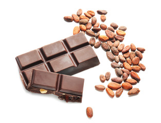 Sweet chocolate and cocoa beans on white background