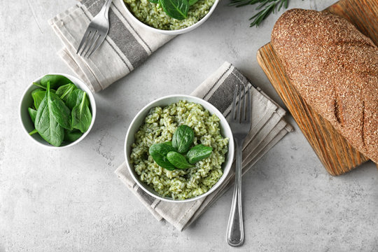Delicious spinach risotto served on table