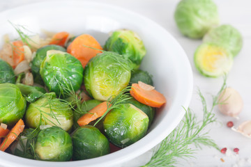 Brussel sprouts with carrot and herbs. Healthy vegetarian food.