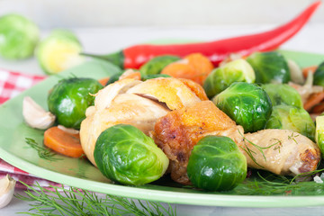 Homemade meal with cooked Brussel Sprouts and chicken drumstick