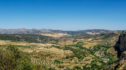 Fototapeta na wymiar Greenery, Mountains, Farms and Fields on the outskirts of Ronda Spain, Europe on a hot summer day