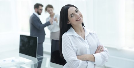 successful young business woman on the background of a workplace